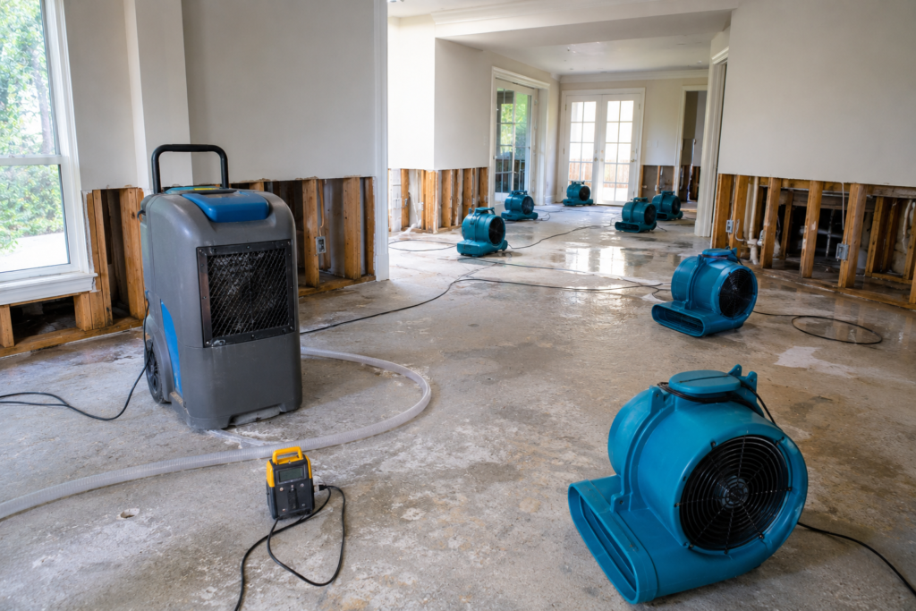 Industrial air movers and dehumidifier set up for structural drying after residential water damage